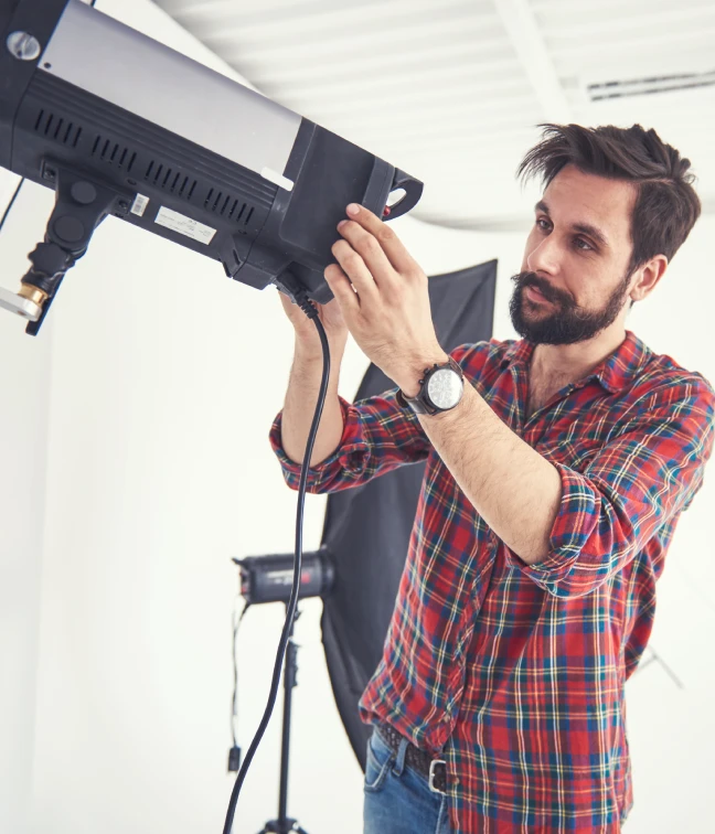 photographer prepares lighting for photo shoot